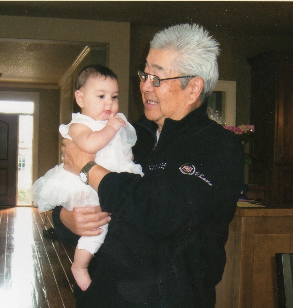 Dick Inukai holds his granddaughter.